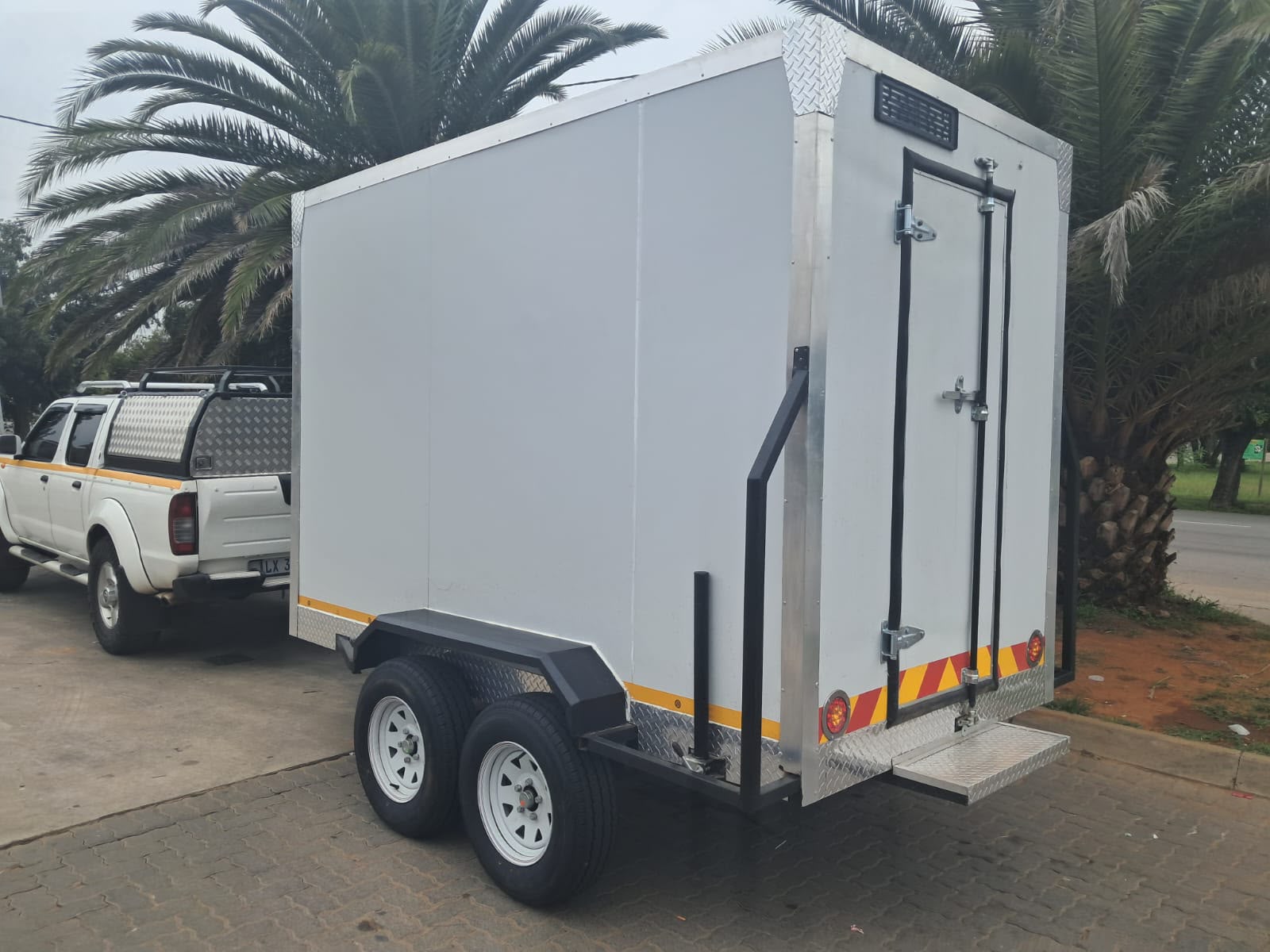 Ndlela Projects Mobile Fridge — Twin-axle unit towed to site